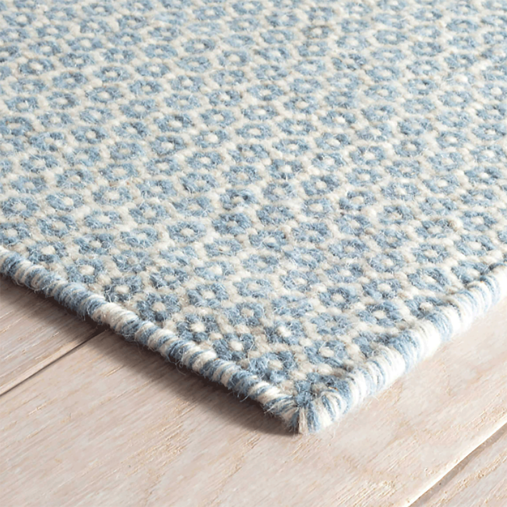 https://www.mainecottage.com/cdn/shop/products/honeycomb-french-blueivory-wool-woven-rug-corner_2048x.gif?v=1653421507
